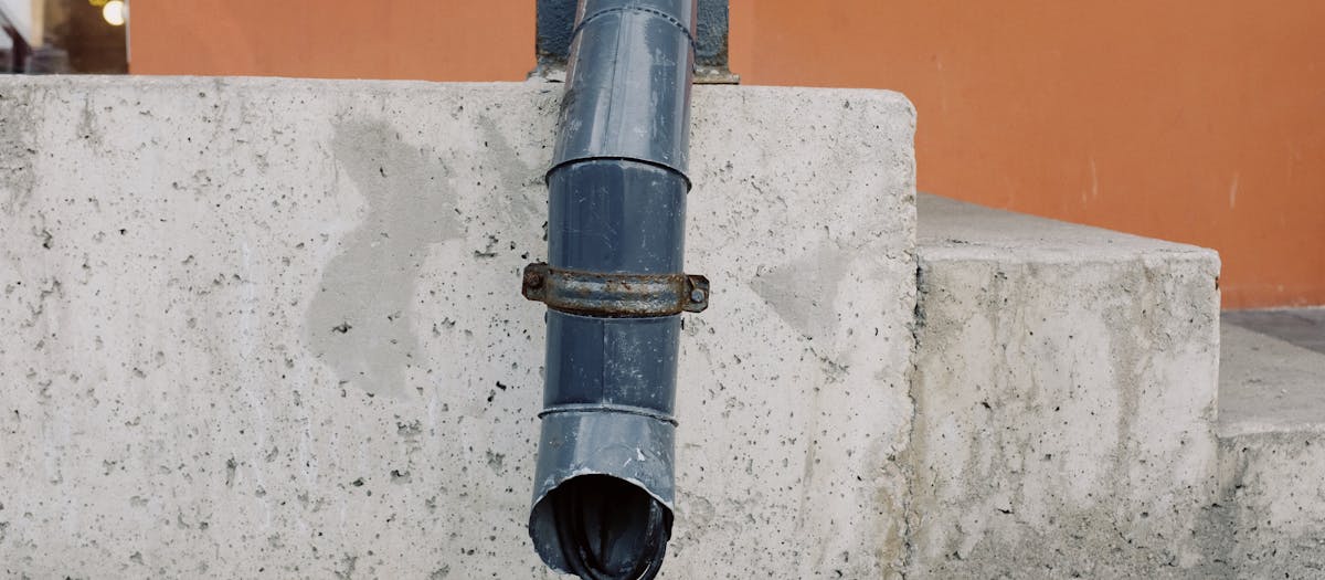 Plumbing drain pipe installation through wall for waste stack